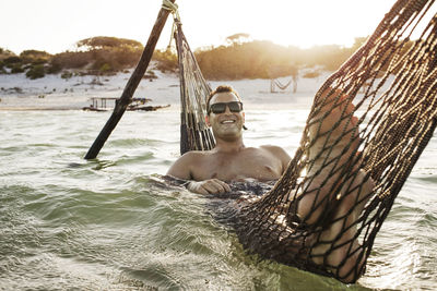 Man lying in hammock smiling