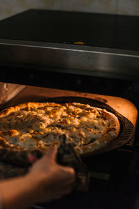 Midsection of person preparing food in kitchen