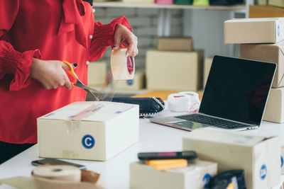 Midsection of man working on table