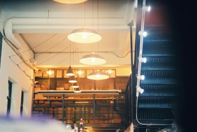 Low angle view of illuminated pendant lights in building