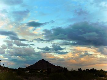 Scenic view of dramatic sky over mountains during sunset