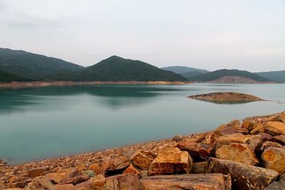 Scenic view of lake and mountains against sky