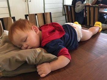 Full length of cute baby girl sleeping at home