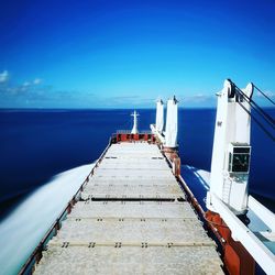 Pier over sea against blue sky