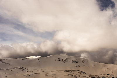 Scenic view of landscape against cloudy sky