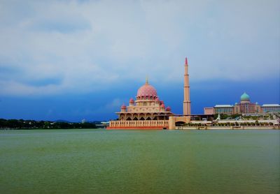 Temple by building against sky