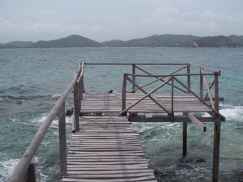 Pier over sea against sky