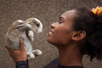 Young woman holding rabbit