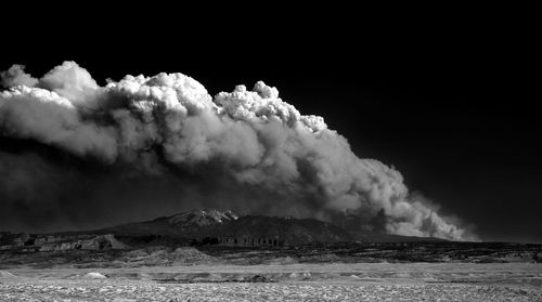 Smoke emitting from volcanic mountain against sky