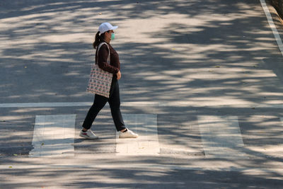 Full length of woman walking on street
