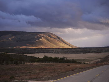 Empty road along countryside landscape