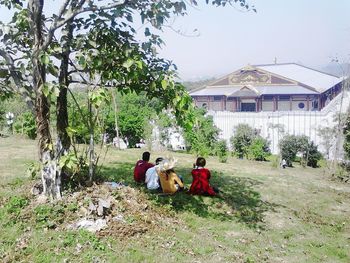 Rear view of man sitting on bench