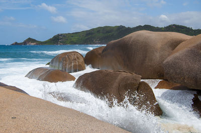 Rocks in sea against sky