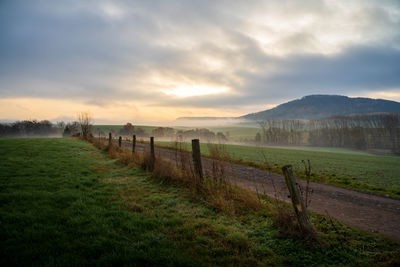 Scenic view of field against sky during sunset