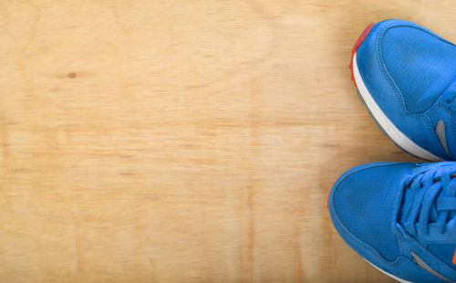Blue shoes on hardwood floor