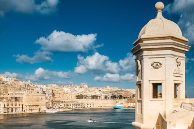 Panoramic view of buildings and sea against sky