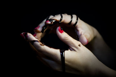 Close-up of woman hand over black background