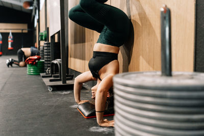 Midsection of woman with arms raised