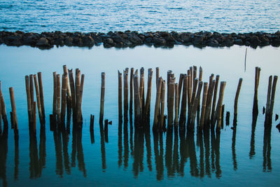 High angle view of wooden posts in sea