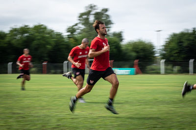 Full length of woman running on grass