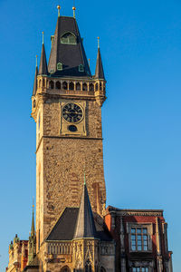 Low angle view of clock tower against clear sky