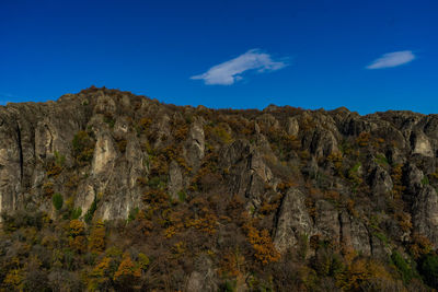 Low angle view of rock formations against sky