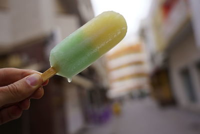 Close-up of hand holding ice cream