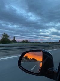 Reflection of sky on side-view mirror