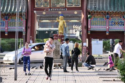 Group of people walking in front of building