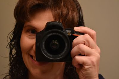 Close-up portrait of woman photographing