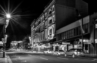 City street amidst buildings at night