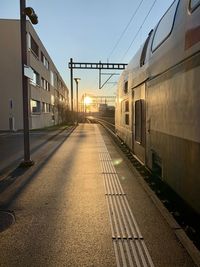 Train on railroad tracks in city against sky