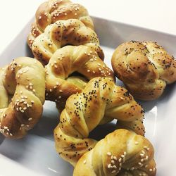 Close-up of croissants in plate over white background