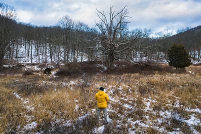 Rear view of person on snow covered land