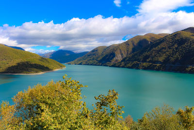 Scenic view of lake and mountains against sky