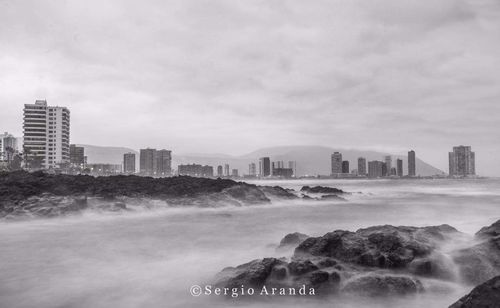 View of city skyline against cloudy sky