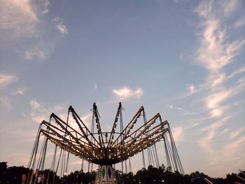 Low angle view of amusement park ride against sky