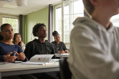 Side view of business colleagues working at office