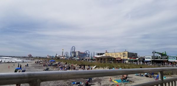 People at beach against sky