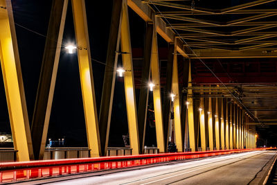 Light trails on bridge in city at night