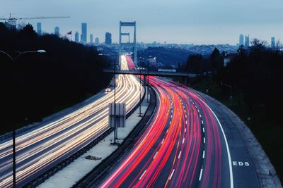 High angle view of light trails on road against sky in city