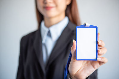 Midsection of businessman using mobile phone