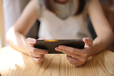 Midsection of woman using mobile phone