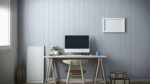 Empty chairs and table against wall at home