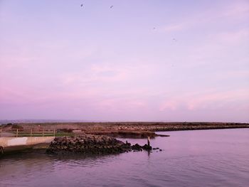 Scenic view of sea against sky at sunset