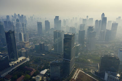 High angle view of modern buildings in city against sky