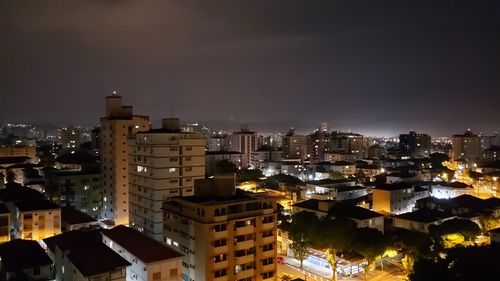 High angle view of illuminated buildings in city at night