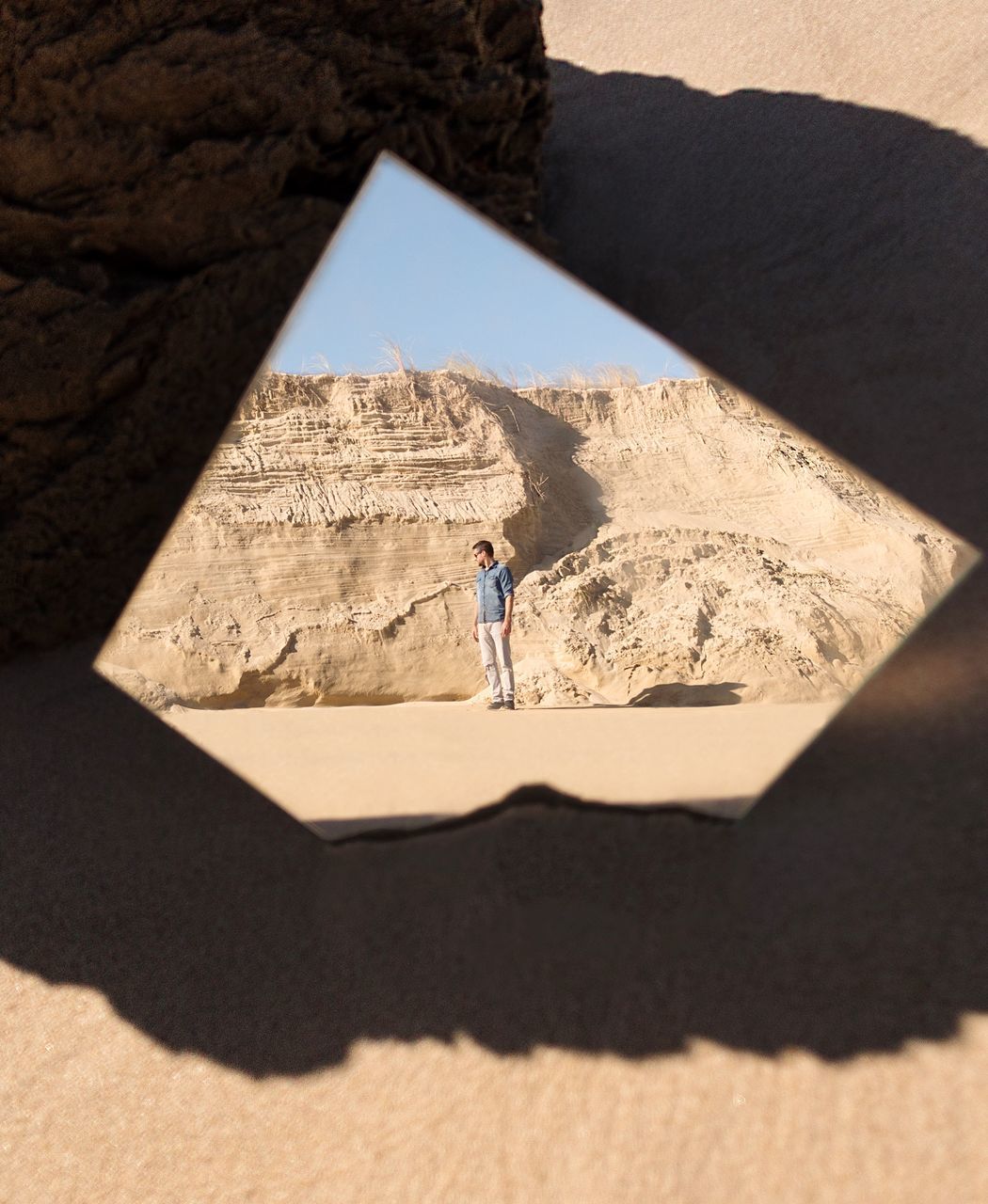 shadow, sunlight, desert, sand, one person, arid climate, day, real people, leisure activity, adventure, exploration, travel destinations, outdoors, full length, lifestyles, sand dune, architecture, nature, adult, people