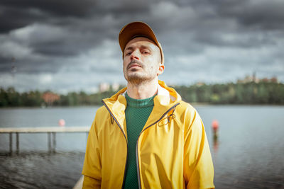 Portrait of young man against lake