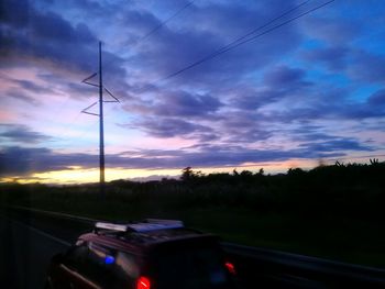 Windmill against sky at sunset